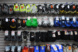 Picture of dozens of pairs of work gloves, sport gloves, hunting gloves, thermal gloves, leather gloves and deer skin gloves on our in-store display in our Erie, PA store.