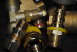 Large assortment of brass industrial fittings displayed on the custom hydraulic tube work bench at Sirco Industrial Supply in Erie, PA.
